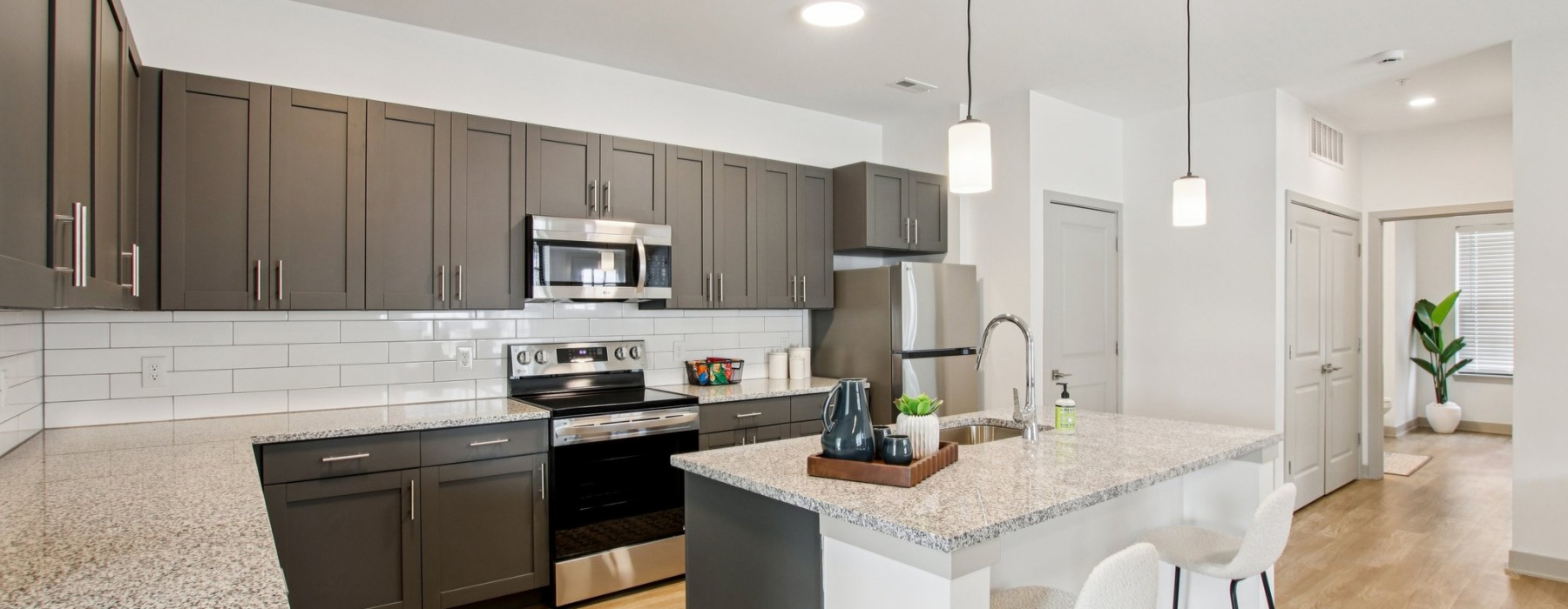 Apartment kitchen with brown cabinets and granite countertops