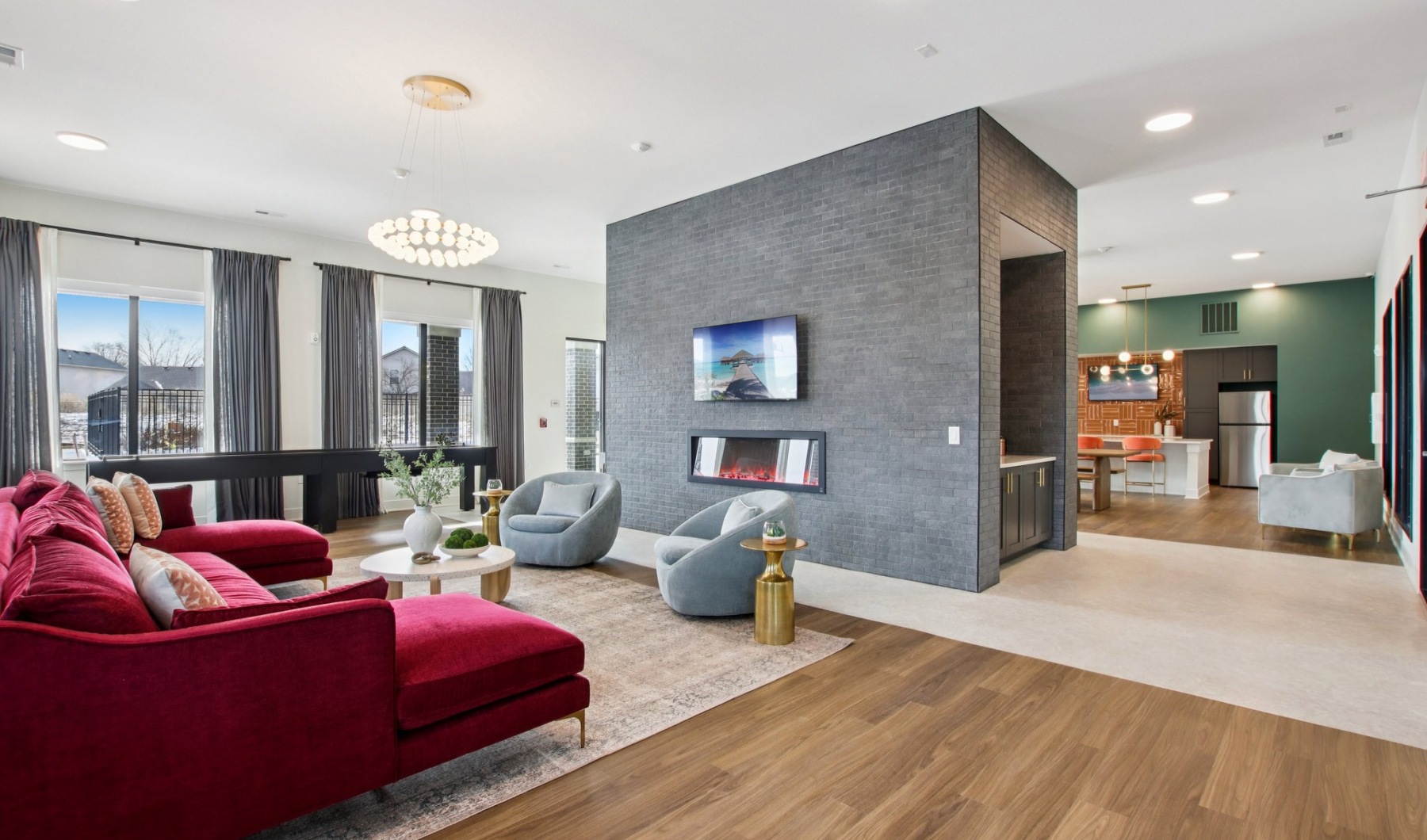 Clubhouse with gray brick fireplace and pink sofa