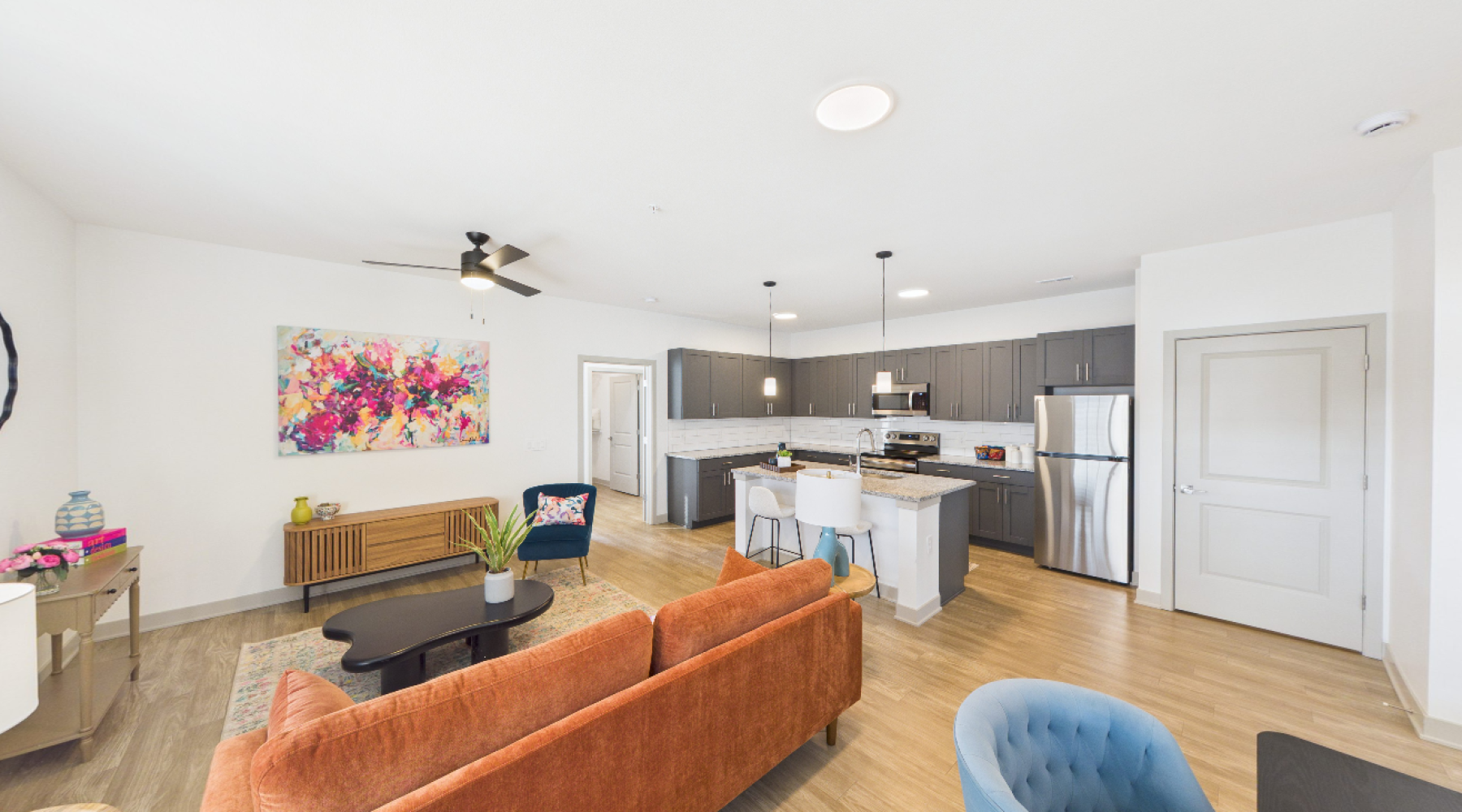 Styled living room and kitchen with floral wall art